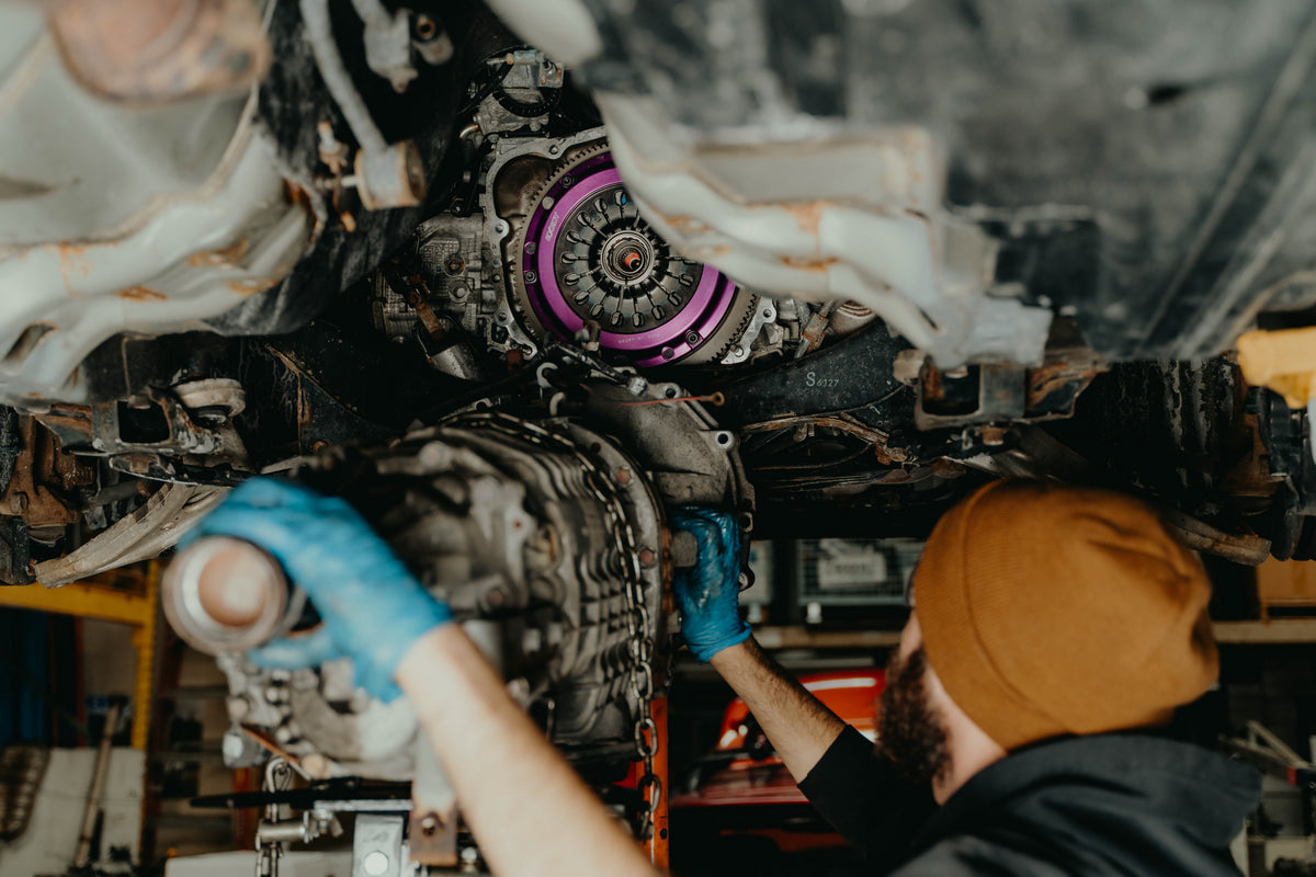 Technician installing a performance clutch on a Subaru transmission at OAKOS